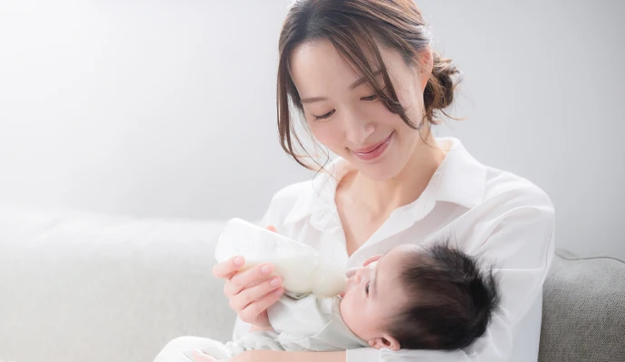 赤ちゃんにミルクを飲ませている写真